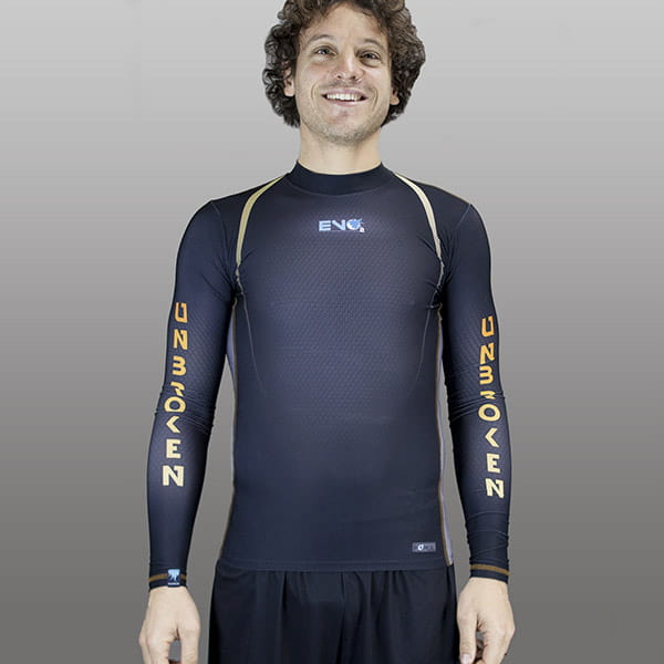 man smiling wearing a black and yellow compression top with long sleeves