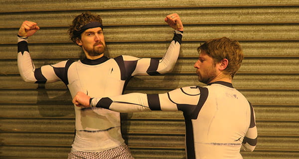 thumbnail two men flexing wearing a white compression top with long sleeves