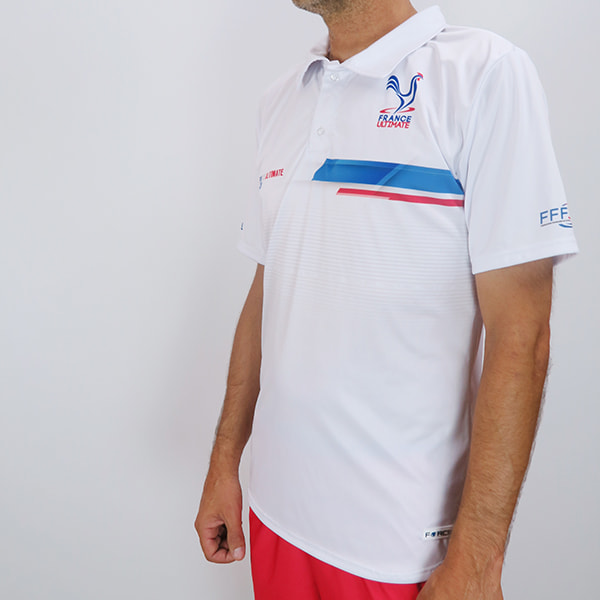 side view of torso of man wearing a white france ultimate polo shirt