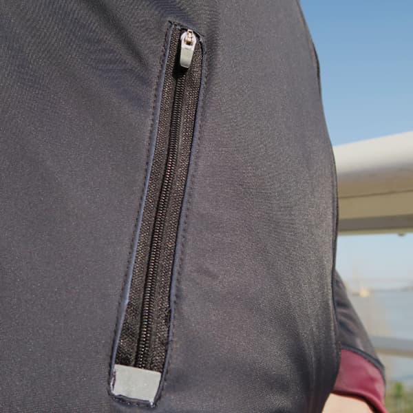 zipped side pocket of a black sport jacket