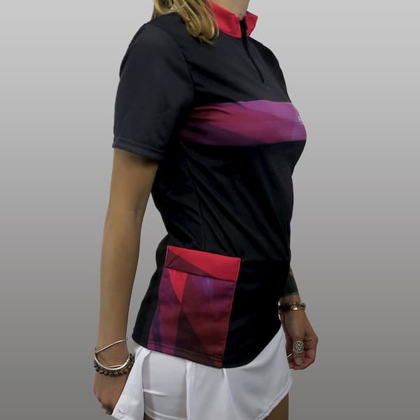 side of woman wearing a black and pink trekking jersey