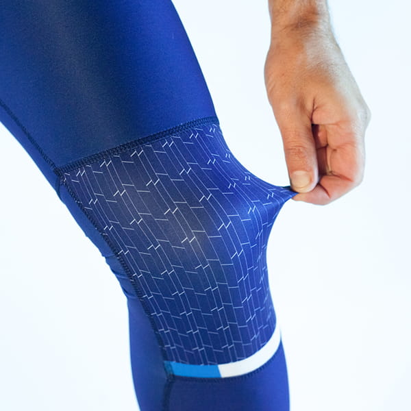 hand stretching fabric of blue legging from the knee