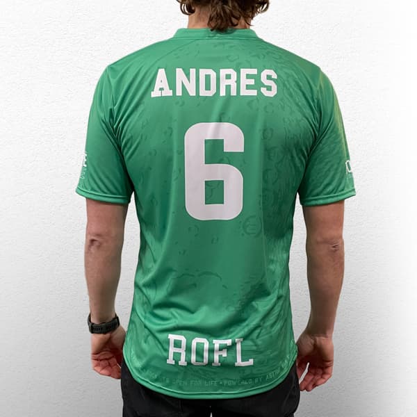 back of man wearing a green sublimated jersey #6