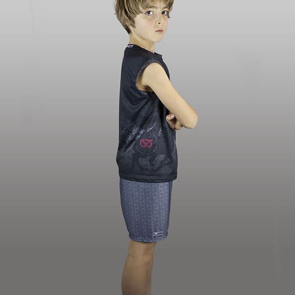 thumbnail side view of kid wearing grey shorts and black singlet arms crossed