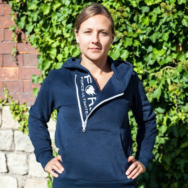 woman wearing a dark blue hoodie with hood down