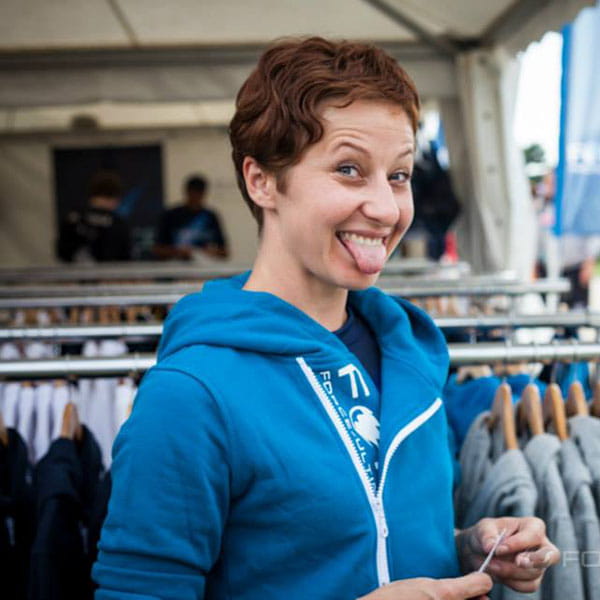 woman wearing a light blue hoodie sticking her tongue out