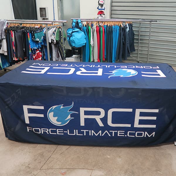 blue force table cover with rack of clothes in garage