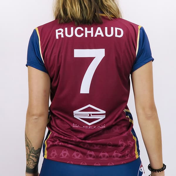 back of woman wearing a red and blue volleyball jersey #7