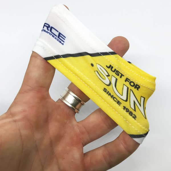 hand stretching fabric of a white and yellow wristband on white background