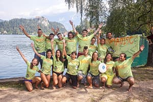 nomadisc team posing in front of a lake