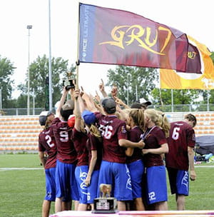 grut team gathering and holding a flag